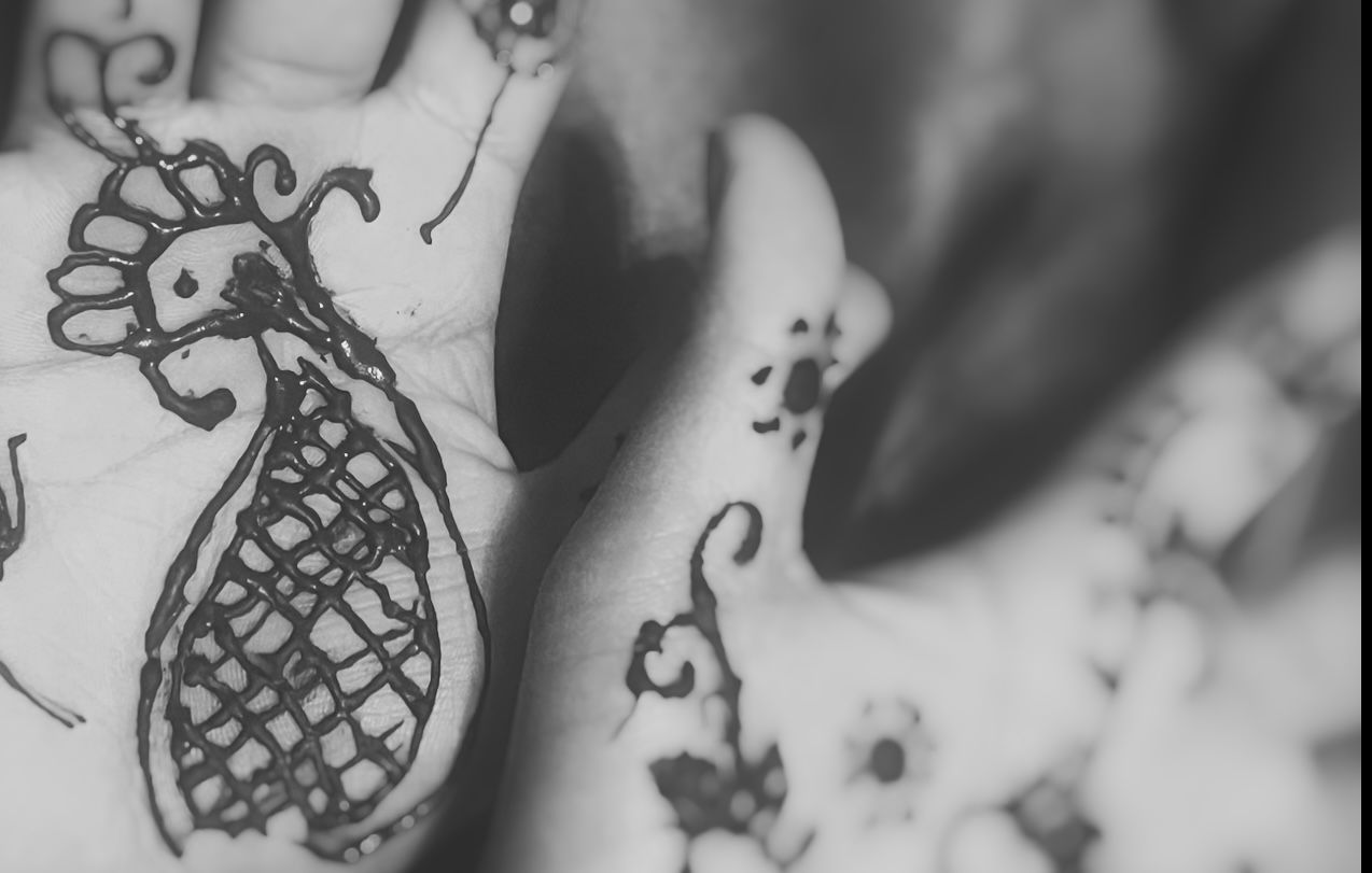 Black and white image of henna on hands.